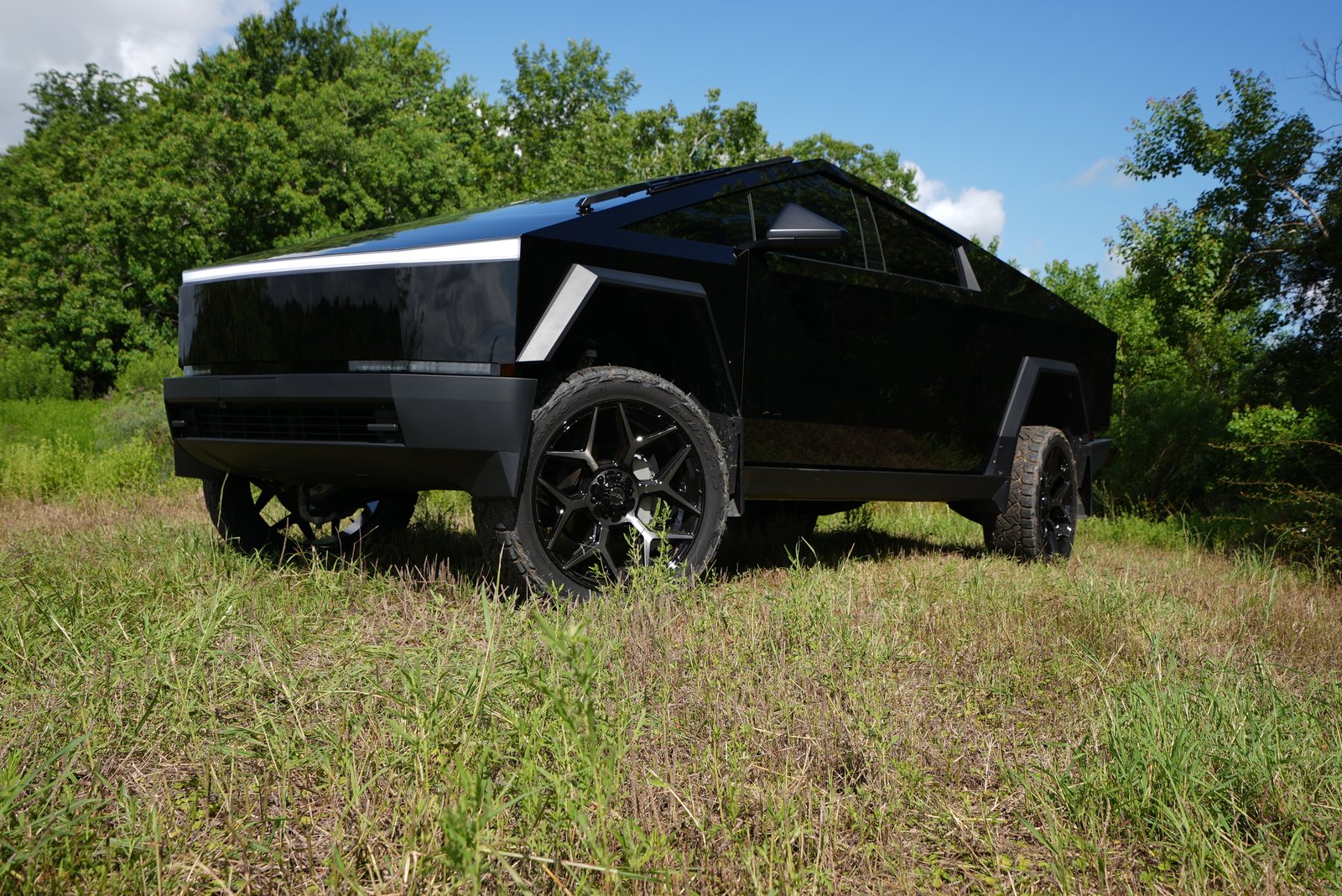 Gloss black Cybertruck high angle in field