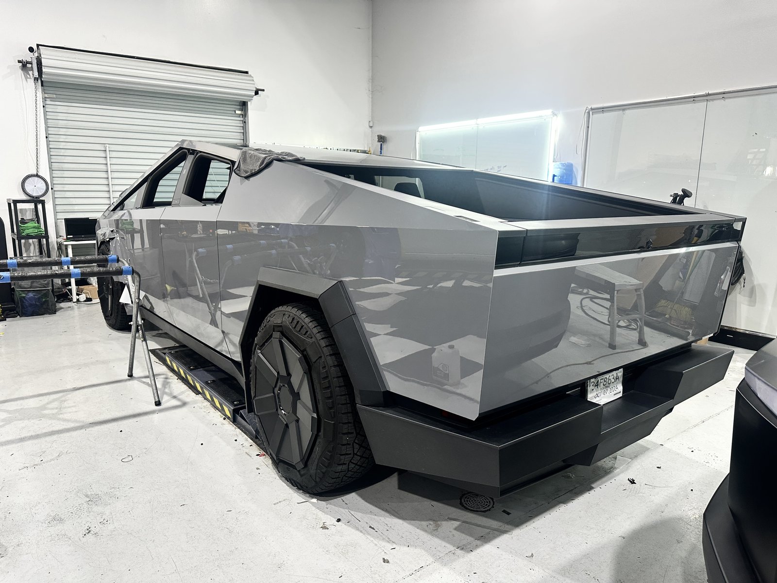 Gray Cybertruck on lift in EVS shop