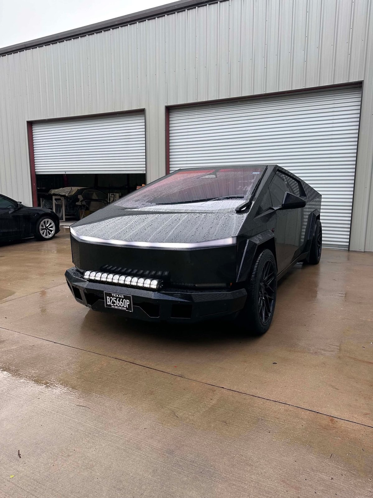 Matte black Cybertruck with widebody flares, T Sportline front bumper and Rigid Industries LED light bar at EVS Motors