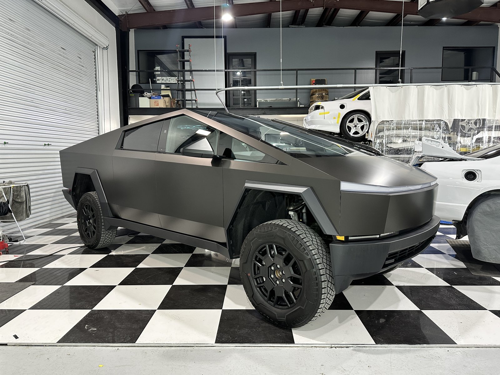 Matte dark Cybertruck on checkered floor