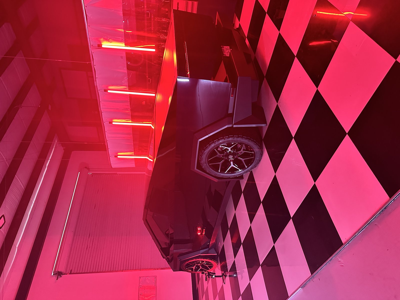 Red Cybertruck under studio lighting at EVS