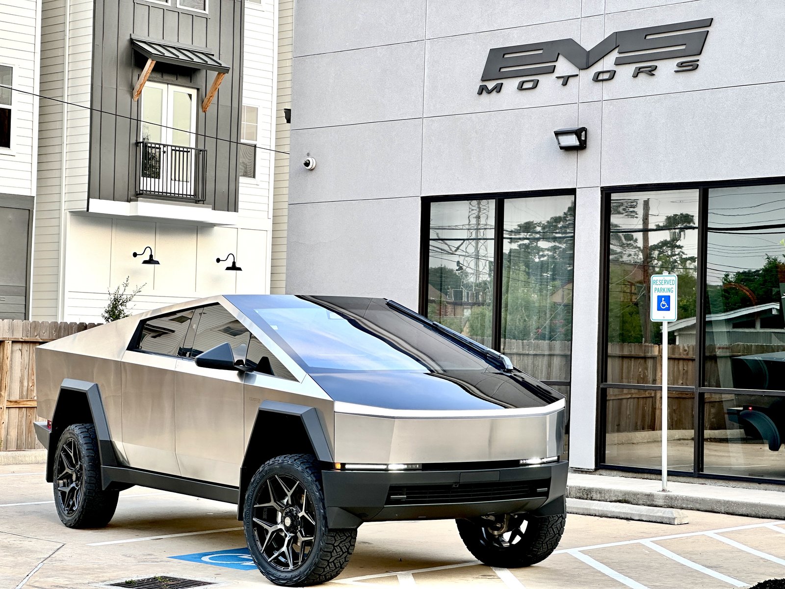 Stainless Cybertruck with lift wheels at EVS