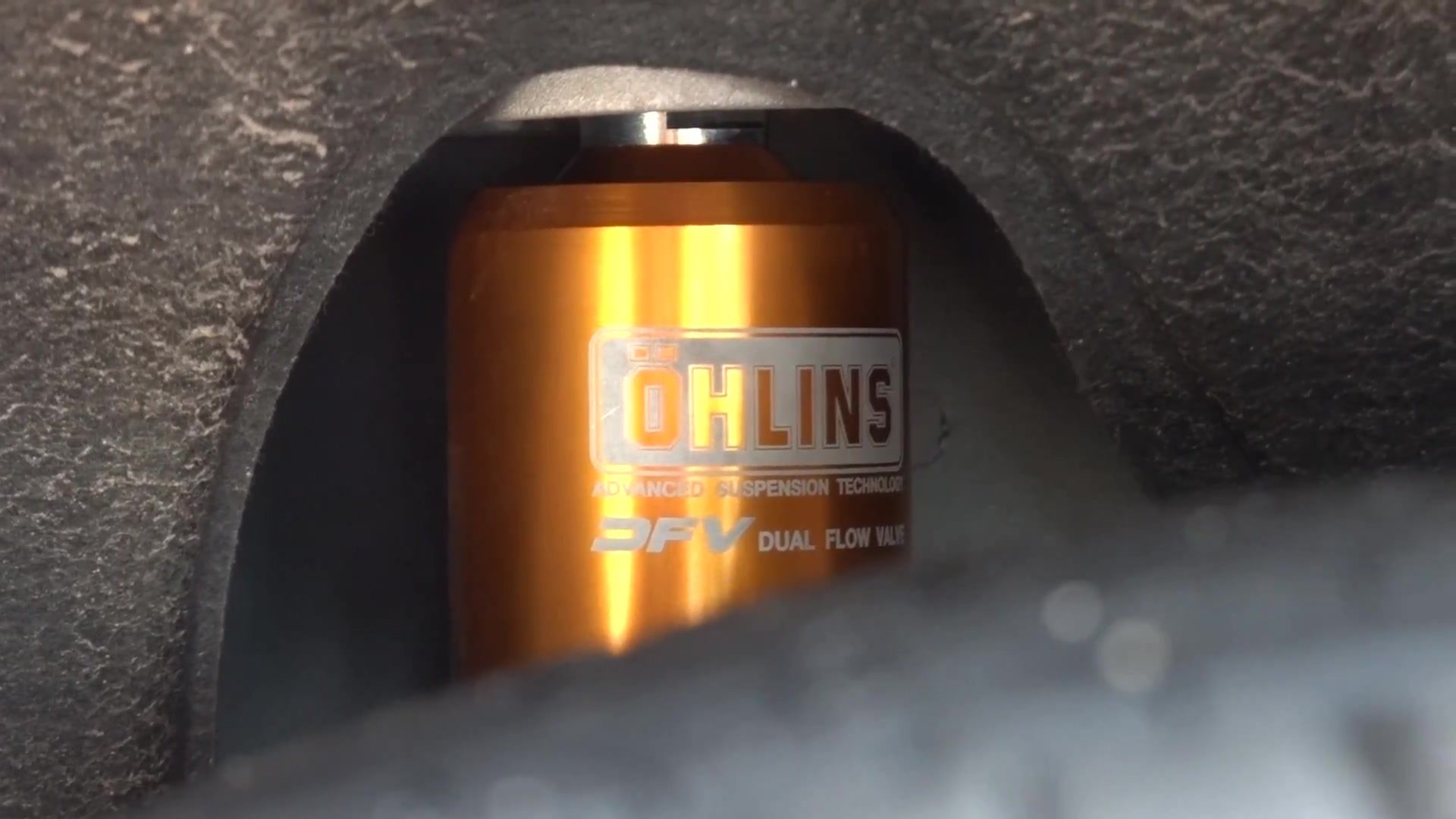 Gold Öhlins damper in the wheel well of a Tesla Model Y